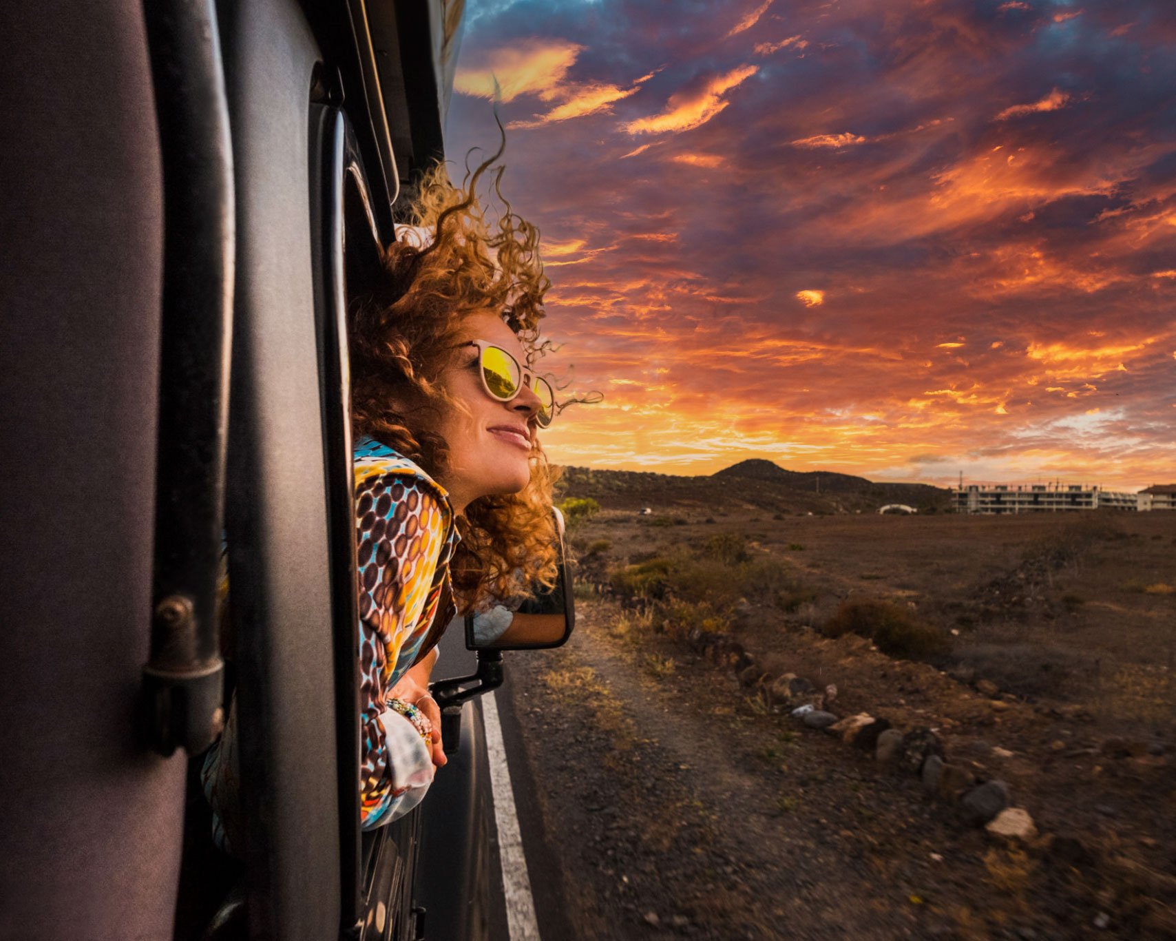Girl leaning out of car window